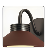Brown wall sconce with a curved design on a white background
