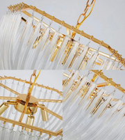 Gold chandelier with crystal-like elements on a light gray background