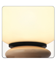 Decorative lamp with a beige shade and wooden base on a white background