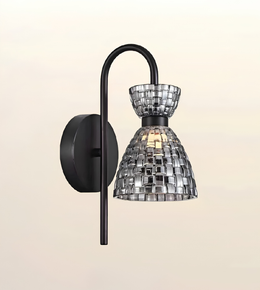 A modern wall sconce light fixture with a matte black curved arm and circular wall mount, featuring a clear glass shade made of reflective mirrored tiles that reflect warm light.
