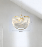 Modern pendant light with gold chain and ribbed glass shade on a white background