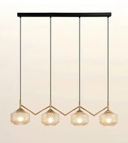 A modern 4-light linear pendant chandelier with textured glass shades and gold-toned geometric accents, suspended from a black horizontal bar against a warm off-white background.