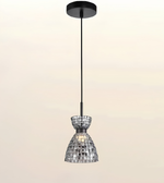 A modern pendant light with a black ceiling canopy and cord, featuring a clear glass shade covered in small reflective silver tiles, shown against a plain light beige background.