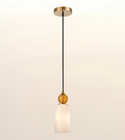 A modern single-light pendant lamp with a black cord, gold-toned metal canopy and decorative accents, and a frosted white glass shade, shown against a plain light background.