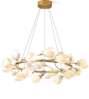 Modern chandelier with gold frame and white floral-like shades on a white background