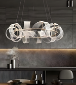 Modern dining room with dark wood table and chairs, marble backsplash, and decorative wall.