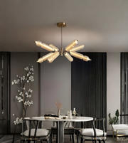 Modern chandelier in a dining room setting with a neutral color palette.