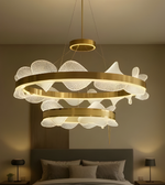 Decorative chandelier hanging above a bed in a bedroom setting.