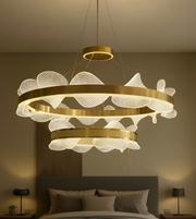 Decorative chandelier hanging above a bed in a bedroom setting.