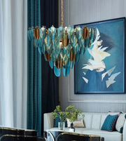 Luxury chandelier in a stylish living room with a painting of birds.