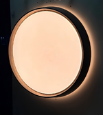 Round ceiling light fixture on a dark background