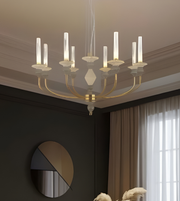 Chandelier hanging in a room with dark walls and a window.