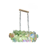 Contemporary gold-finished art glass dining chandelier featuring iridescent circular glass panels with warm lighting.