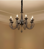 Chandelier hanging from the ceiling in a room with beige walls.