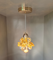 Gold pendant light fixture hanging from a ceiling