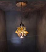 Gold pendant light fixture hanging from a ceiling