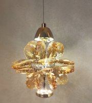 Gold pendant light fixture hanging from a ceiling