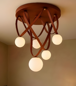 Ceiling light fixture with wooden design and multiple round lights on a neutral background