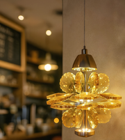 Gold pendant light fixture hanging from a ceiling
