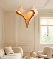 Heart-shaped pendant light in a living room with neutral decor