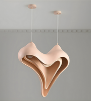 Modern pendant light with a unique, wavy design on a gray background