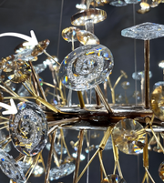Close-up of a luxurious chandelier with crystal and gold details against a dark background