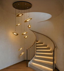 Modern orbit disc cascade staircase chandelier with warm LED lighting in a luxury interior