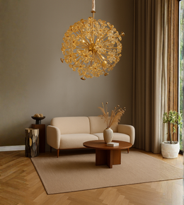 Solérre gold chandelier with petal design hanging above a sofa in a living room.