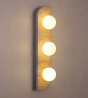 Wall-mounted light fixture with three round lights on a neutral background