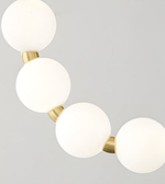 Ceiling light fixture with white spherical lights and gold accents on a gray background