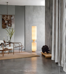 Sculptural ribbed floor lamp with warm glow in modern living room