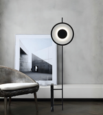 Contemporary ring-shaped LED standing lamp beside sofa in living room