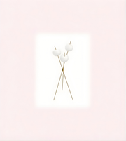 Minimalist gold tripod floor lamp with triple opal glass globes on white background