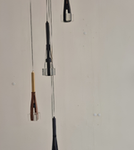 Two hanging lamps with different design elements on a plain background