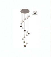 Modern pendant light with hanging spherical elements on a white background, branded 'Dubai Lights'.
