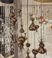 Decorative hanging lights with glass and metal design in a room setting.