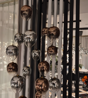 Decorative hanging lights with reflective globes in a modern interior setting.
