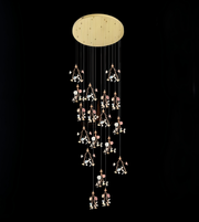 Decorative ceiling light fixture with hanging elements on a black background