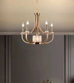 Modern gold chandelier with five candle-style LED lights in an elegant interior setting