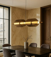 Modern glass pendant light above marble dining table in elegant dining room interior