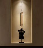 Amber Aura Pendant hanging from a ceiling, featuring a warm amber-colored glass shade and modern design by Daya Worldwide.