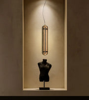 Amber Aura Pendant hanging from a ceiling, featuring a warm amber-colored glass shade and modern design by Daya Worldwide.
