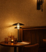 Daya Worldwide Zen Eclipse table lamp with a sleek, modern design and a soft glowing light on a contemporary side table.